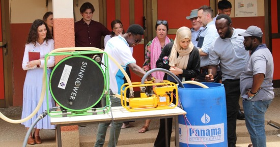  Husker representatives watch a demonstration of two kinds of solar-powered water pumps at the Don Bosco Solar and Renewable Energy Center in Ghana. They are (from left) Cheyenne Gerlach, assistant director, Yeutter Institute; Renata Rimšaitė, senior program manager, Water for Food; Matthew Gillespie and Lexi Bodlak, student fellows; Hugues Dossou Espoir, Don Bosco employee; Erin Anders, senior program manager, Water for Food; Zanib Al Razaq, student fellow; Jude Cobbing, senior program manager, Water for Food; Nick Brozović, director of policy, Water for Food; Ethan Zen, student fellow; Emmanuel Tamba Sesay, Don Bosco employee; and Lewis Adjei-Banin, tour guide. (David K. Bakayona/Don Bosco)