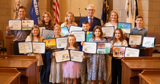 Lt. Gov. Joe Kelly and Nebraska Department of Water, Energy, and Environment Director Jesse Bradley honored 13 students whose artwork was chosen to be part of the 2026 “Nebraska: Don’t Waste It!” Calendar. Pictured are, from left: (front row) Grace Schmidt, Eliana Garwood, and Olivia Whiteface; (second row) Evlyn Kunzman, Dayton Cunningham, and Rocky Falcone; and (back row) Director Bradley, Hannah Pokrinchak, Briley Dohmen, Lt. Gov. Kelly, Coralee Schurr, and River Case. Not pictured are Clara Fehringer, Eden Duryea, and Brenda Hernandez.